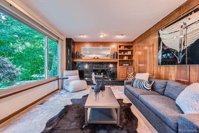 4878 W 98th Ave, Westminster, CO 80031 - carpeted living room featuring a high end fireplace, built in features, and wooden walls