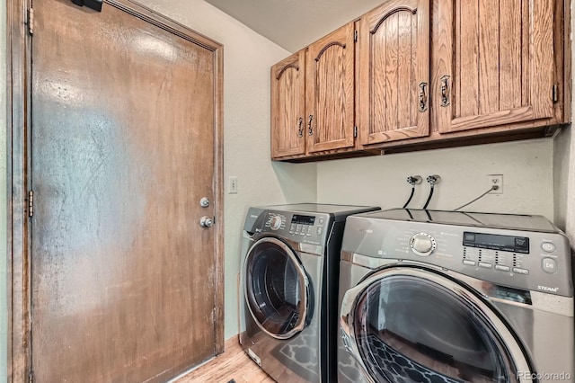 4878 W 98th Ave, Westminster, CO 80031 - washroom featuring washing machine and dryer, cabinet space, and light wood-style flooring