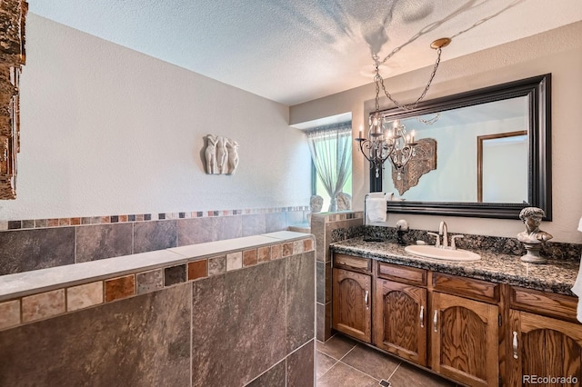 4878 W 98th Ave, Westminster, CO 80031 - full bath featuring vanity, tile patterned flooring, a chandelier, and a textured ceiling
