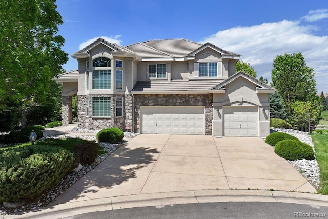 9278 E Aspen Hill Pl, Lone Tree, CO 80124 - view of front of property featuring stone siding, stucco siding, concrete driveway, and an attached garage