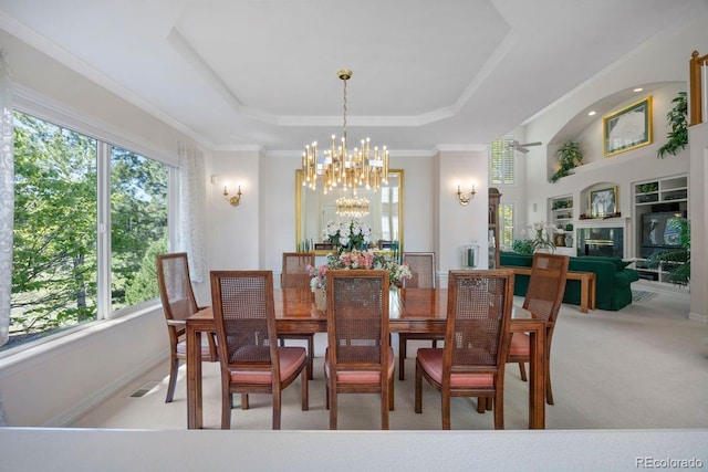 9278 E Aspen Hill Pl, Lone Tree, CO 80124 - carpeted dining area with a chandelier, plenty of natural light, a raised ceiling, and a glass covered fireplace
