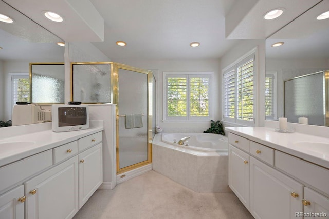 9278 E Aspen Hill Pl, Lone Tree, CO 80124 - bathroom featuring two vanities, a stall shower, a bath, and recessed lighting