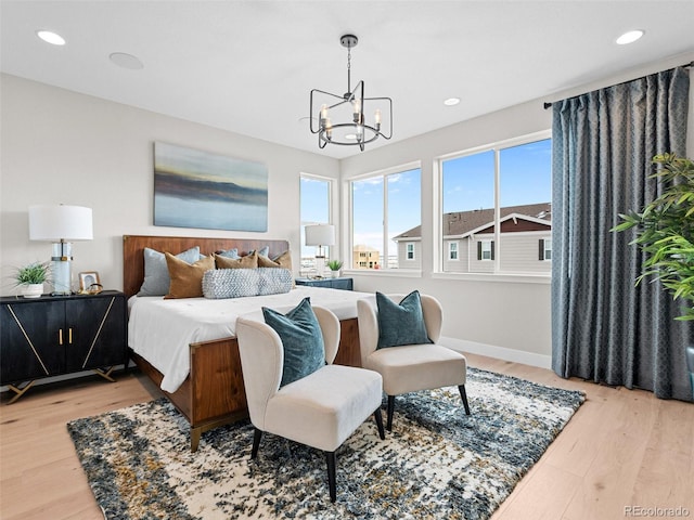 bedroom featuring hardwood / wood-style flooring and a notable chandelier