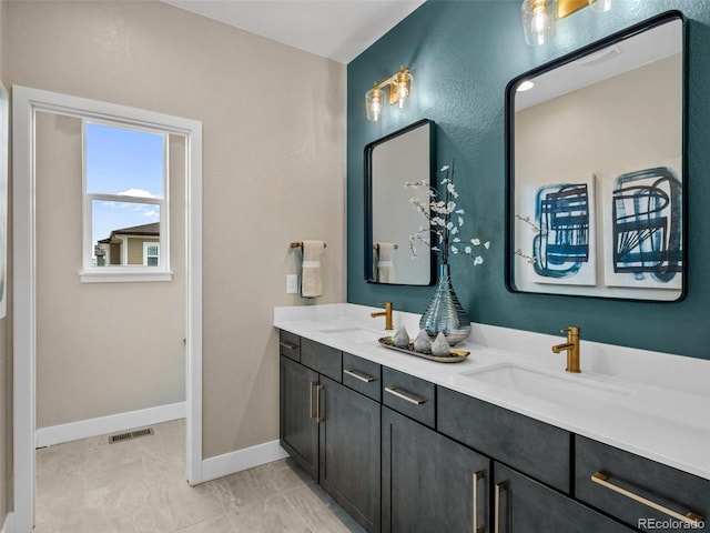 bathroom with tile patterned flooring and vanity