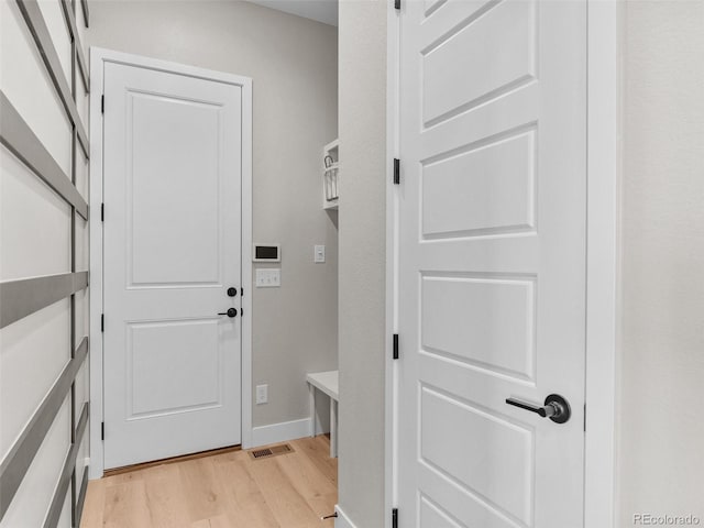 mudroom with light hardwood / wood-style floors