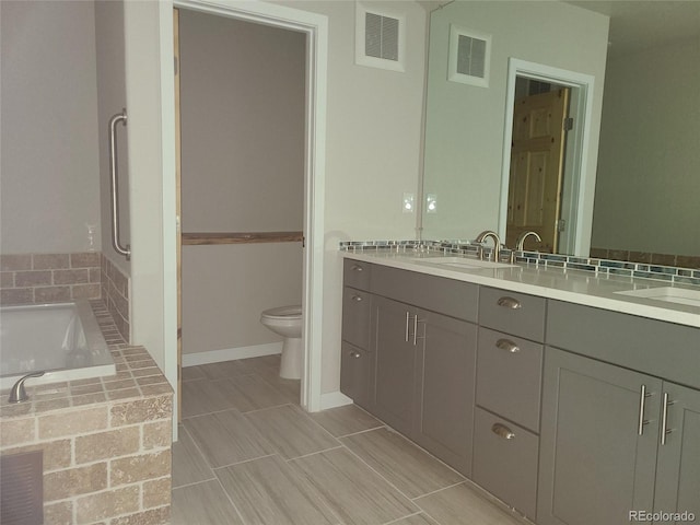 bathroom featuring visible vents, a sink, and toilet