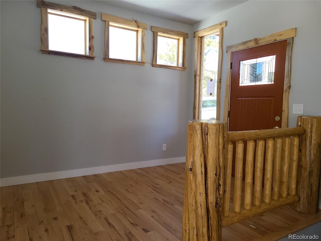 foyer featuring light wood-style floors and baseboards