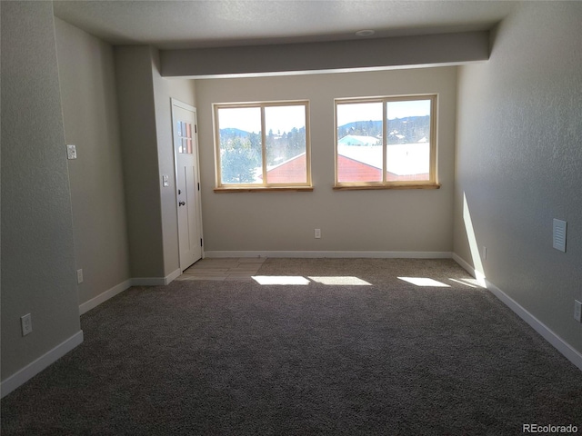 unfurnished room with light colored carpet and baseboards