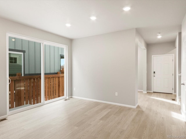 empty room featuring recessed lighting, baseboards, and wood finished floors