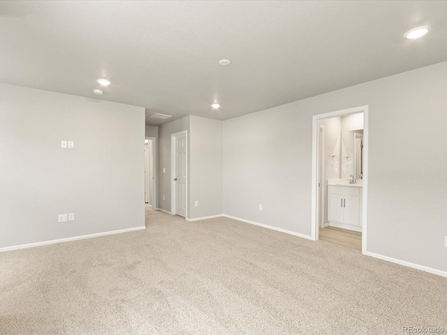 unfurnished room with light carpet, recessed lighting, and baseboards