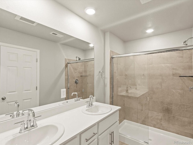 bathroom featuring a sink, visible vents, and a stall shower