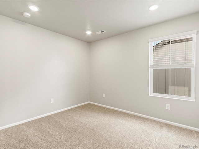 carpeted empty room with recessed lighting, visible vents, and baseboards