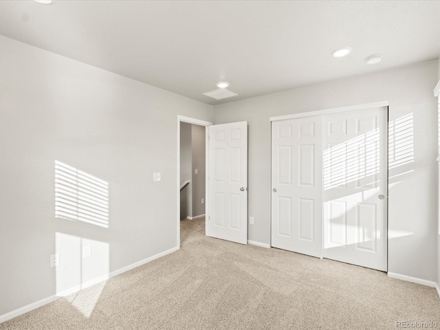 unfurnished bedroom with carpet, baseboards, and a closet