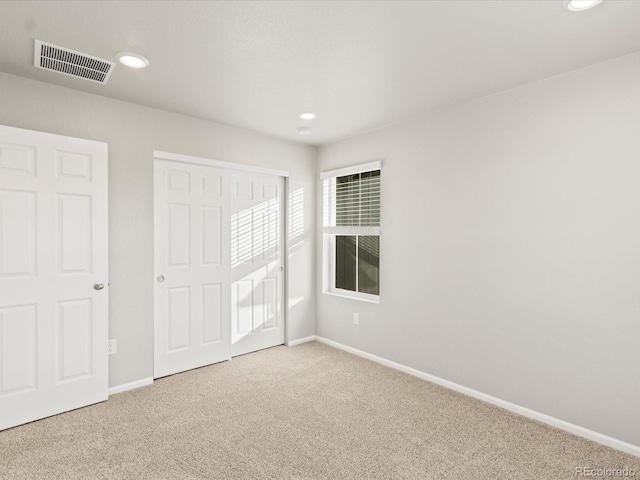 unfurnished bedroom featuring visible vents, baseboards, carpet floors, recessed lighting, and a closet