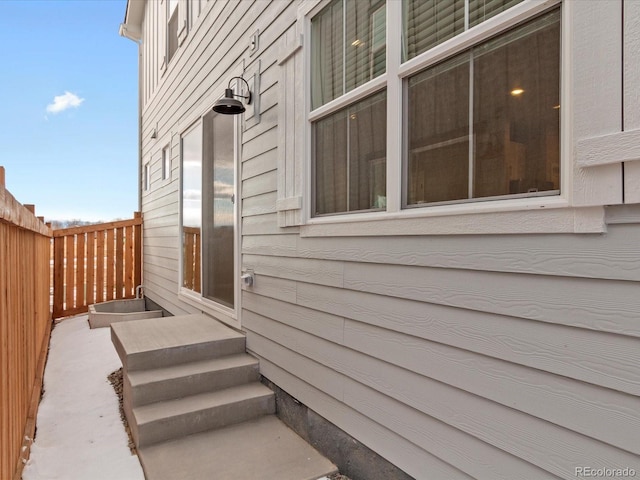 doorway to property featuring fence