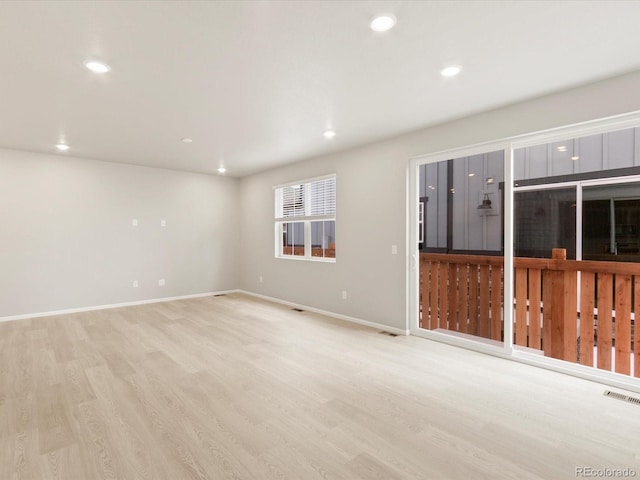 empty room with visible vents, recessed lighting, baseboards, and light wood-style floors