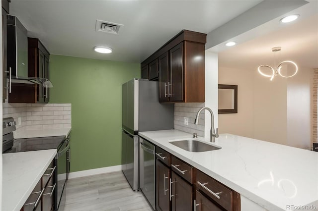 800 N Pearl St Unit 611, Denver, CO 80203 - kitchen featuring appliances with stainless steel finishes, a sink, wall chimney exhaust hood, light wood-style floors, and decorative backsplash