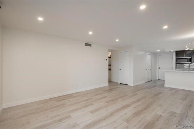 800 N Pearl St Unit 611, Denver, CO 80203 - unfurnished living room with light wood-style flooring, recessed lighting, and baseboards