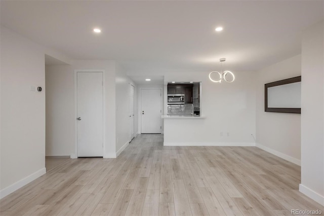 800 N Pearl St Unit 611, Denver, CO 80203 - unfurnished living room with a chandelier, light wood-style floors, baseboards, and recessed lighting