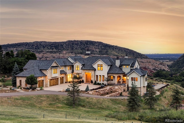 view of front of property featuring a garage and a mountain view