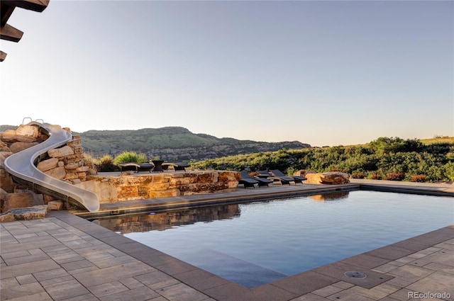 pool at dusk with a mountain view