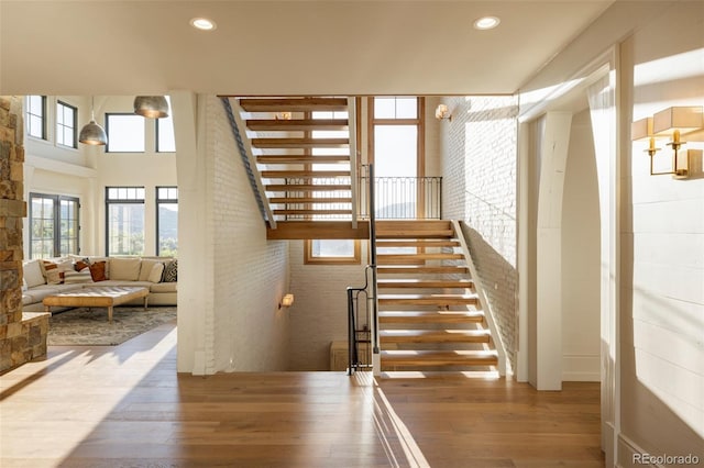 stairs featuring hardwood / wood-style floors