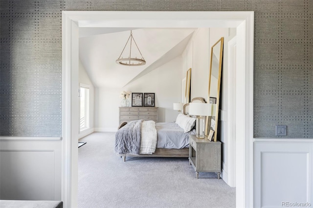 carpeted bedroom with lofted ceiling