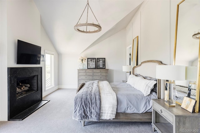 bedroom with lofted ceiling and light colored carpet