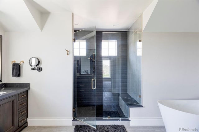 bathroom featuring independent shower and bath and vanity