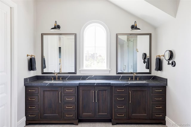 bathroom with vaulted ceiling and vanity