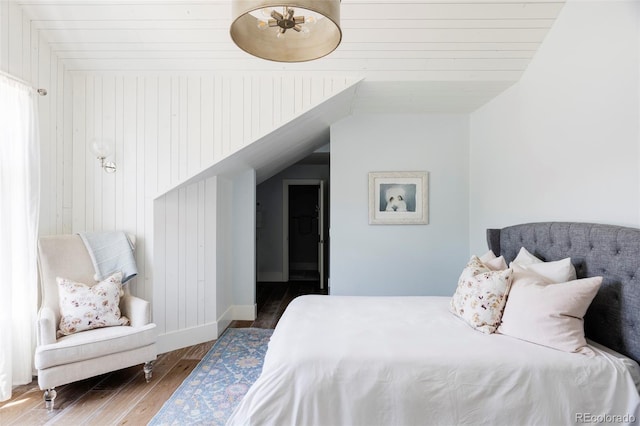 bedroom with lofted ceiling and dark wood-type flooring