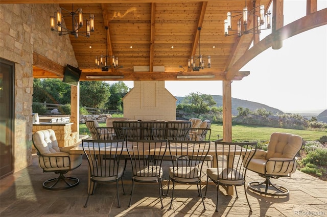 view of patio / terrace with a bar and an outdoor stone fireplace