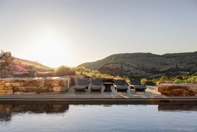 view of swimming pool featuring a water and mountain view