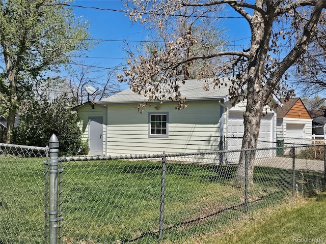 3798 S Grant St, Englewood, CO 80113 - view of side of home featuring a lawn, fence, a shingled roof, and an attached garage