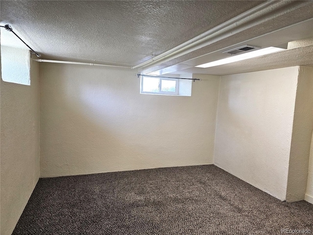 3798 S Grant St, Englewood, CO 80113 - below grade area with carpet floors, a textured ceiling, a textured wall, and visible vents