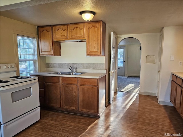 3798 S Grant St, Englewood, CO 80113 - kitchen with a sink, light countertops, arched walkways, electric stove, and a healthy amount of sunlight