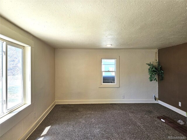 3798 S Grant St, Englewood, CO 80113 - unfurnished room with baseboards, dark colored carpet, and a textured ceiling