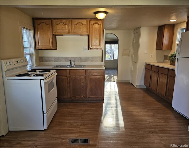 3798 S Grant St, Englewood, CO 80113 - kitchen with white appliances, dark wood-style flooring, a sink, and light countertops
