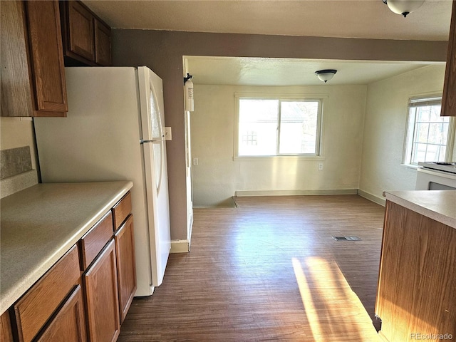 3798 S Grant St, Englewood, CO 80113 - kitchen with white appliances, baseboards, visible vents, and dark wood-type flooring
