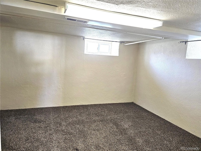 3798 S Grant St, Englewood, CO 80113 - basement featuring carpet floors, a textured wall, and visible vents