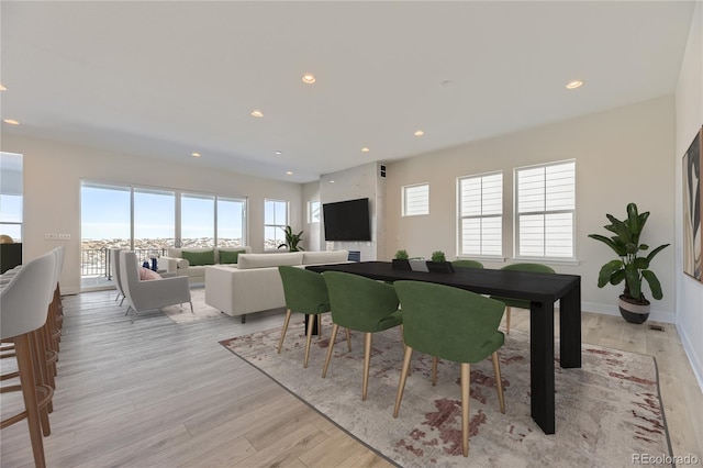 dining space with a healthy amount of sunlight and light wood-type flooring