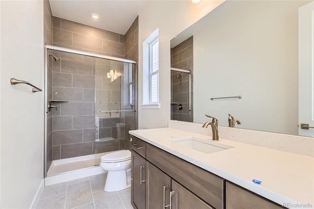 bathroom with tile patterned flooring, vanity, toilet, and walk in shower