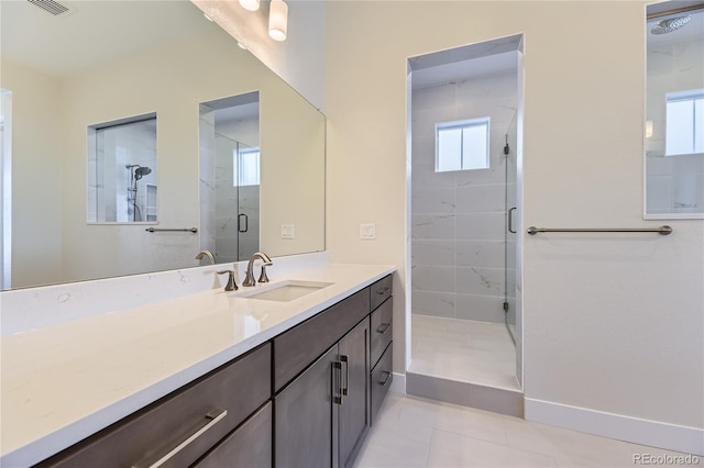 bathroom featuring tile patterned flooring, vanity, and a shower with shower door