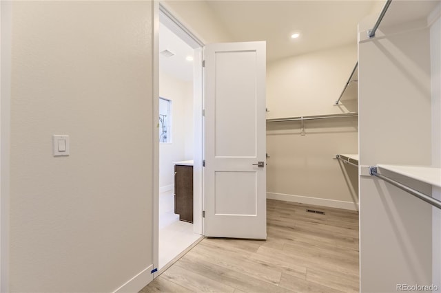 walk in closet featuring light hardwood / wood-style floors