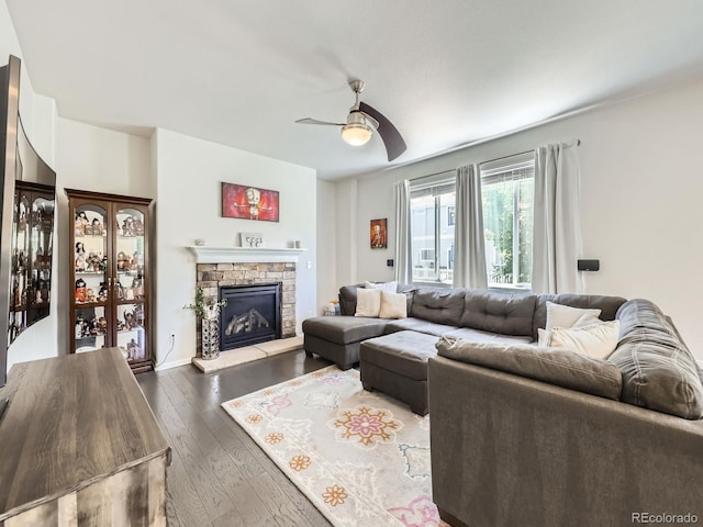 3508 E 140th Pl, Thornton, CO 80602 - living area with dark wood-style flooring, ceiling fan, and a stone fireplace