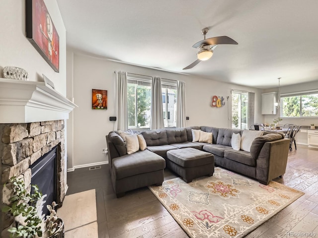 3508 E 140th Pl, Thornton, CO 80602 - living area featuring a ceiling fan, dark wood-style flooring, and a fireplace