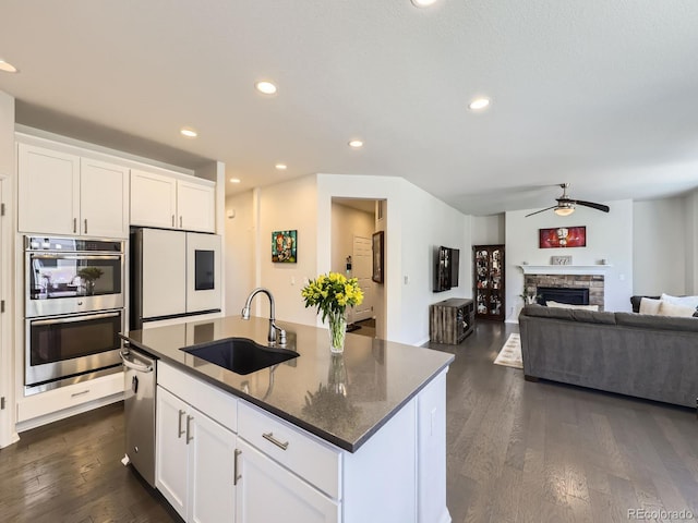 3508 E 140th Pl, Thornton, CO 80602 - kitchen with appliances with stainless steel finishes, a ceiling fan, dark wood finished floors, recessed lighting, and white cabinets