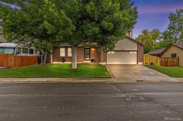 1285 Aberdeen Dr, Broomfield, CO 80020 - obstructed view of property with driveway, a garage, and brick siding