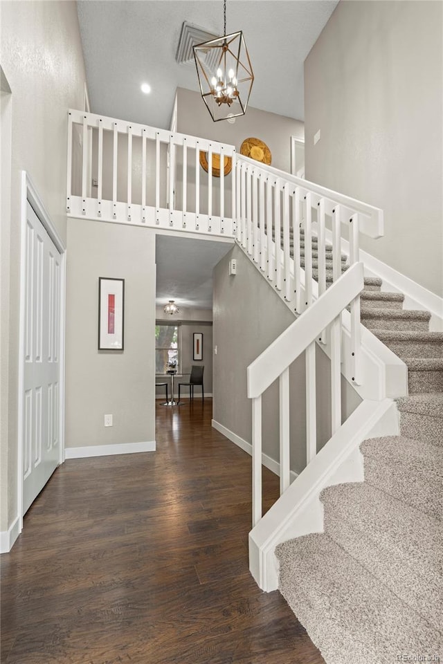 1285 Aberdeen Dr, Broomfield, CO 80020 - stairs featuring a chandelier, wood finished floors, a towering ceiling, baseboards, and recessed lighting