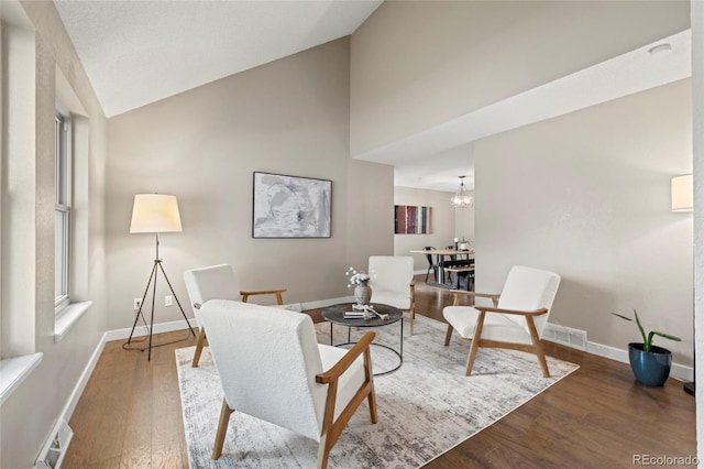 1285 Aberdeen Dr, Broomfield, CO 80020 - living area with wood finished floors, baseboards, a chandelier, and high vaulted ceiling